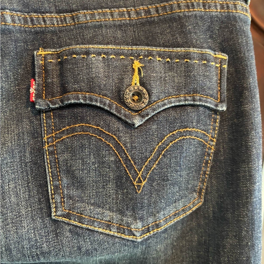 Levi's Dark Blue 526  Mid Rise Slim Boot Cut Jeans with Gold Stitching.